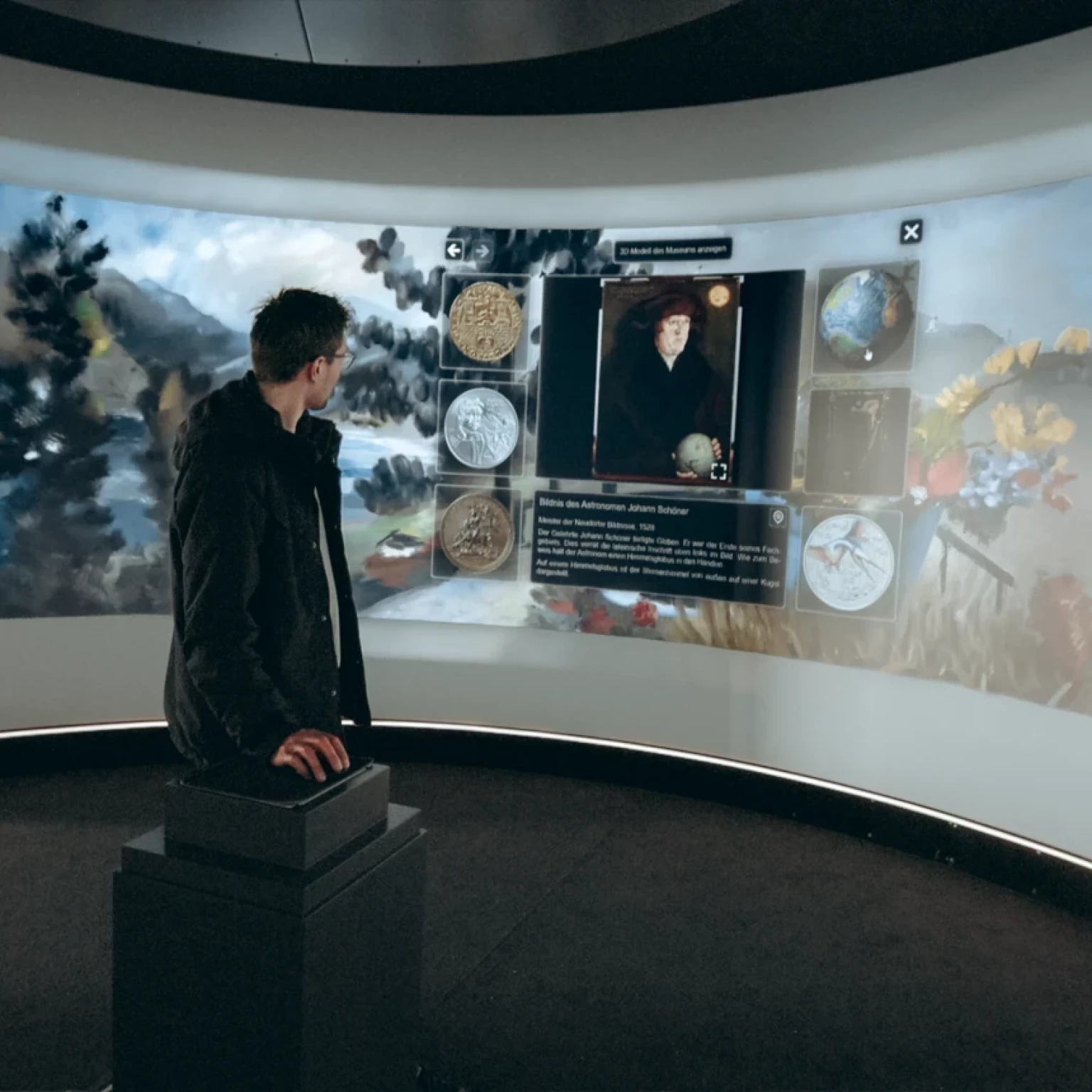 In the immersive space of the State Museum of Hanover, a person can be seen operating the interactive features of the installation.